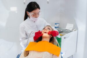 A professional dentist performs treatment and examination of the patient's oral cavity in close-up. Dentistry